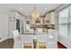 Inviting dining area with a chandelier, white chairs, and natural light, perfect for Gathering meals at 106 Wrigley Blvd, Summerville, SC 29485
