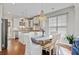 Bright dining area featuring a chandelier, seating for six, and natural light through the windows at 106 Wrigley Blvd, Summerville, SC 29485
