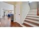 Inviting foyer with hardwood floors, staircase, and an open view into the living room at 106 Wrigley Blvd, Summerville, SC 29485