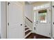 Warm and inviting foyer with hardwood floors, staircase, and natural light streaming through the front door at 106 Wrigley Blvd, Summerville, SC 29485