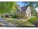 Charming two-story home with manicured lawn and landscaping, mature shade trees, and sidewalks at 106 Wrigley Blvd, Summerville, SC 29485