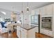 Open concept kitchen with island, stainless appliances, and adjacent dining area at 106 Wrigley Blvd, Summerville, SC 29485