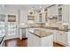 Bright eat-in kitchen features white cabinets, stainless steel appliances, and hardwood floors at 106 Wrigley Blvd, Summerville, SC 29485