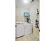 Functional laundry room with a washer, dryer, and storage shelf at 106 Wrigley Blvd, Summerville, SC 29485