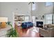 Bright and airy living room featuring a cozy fireplace, high ceilings, and seamless flow to the kitchen at 106 Wrigley Blvd, Summerville, SC 29485