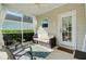 Relaxing screened porch with neutral colored furniture and outdoor rug at 106 Wrigley Blvd, Summerville, SC 29485