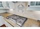 Close-up of a stainless steel gas stove with granite countertops and custom tile work at 106 Wrigley Blvd, Summerville, SC 29485