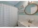 Clean bathroom with tiled shower and a round wooden mirror at 108 Helen Dr, Summerville, SC 29483