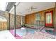 View of a covered carport or patio space with brick features and a red door leading into the home at 108 Helen Dr, Summerville, SC 29483