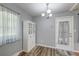 Dining area with wood-look floors, a modern chandelier, built in cabinet and natural light at 108 Helen Dr, Summerville, SC 29483