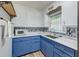 Modern kitchen features blue cabinets and countertops and tile backsplash at 108 Helen Dr, Summerville, SC 29483