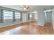 Open-concept living room with hardwood floors, a ceiling fan, and ample natural light from multiple windows at 108 Helen Dr, Summerville, SC 29483