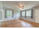 Bright living room featuring hardwood floors, ceiling fan, and three windows offering natural light at 108 Helen Dr, Summerville, SC 29483