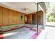 Covered back patio with wood paneling, ceiling fan and painted floor at 108 Helen Dr, Summerville, SC 29483