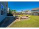 Inviting backyard featuring a stone fire pit, patio, grilling area, and well-maintained lawn at 1110 Sapling Dr, Summerville, SC 29485