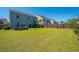 Large grassy backyard is fully fenced for privacy; features a fire pit and patio at 1110 Sapling Dr, Summerville, SC 29485