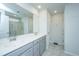 Well-lit bathroom with double sinks, gray cabinets, and a large mirror at 1110 Sapling Dr, Summerville, SC 29485