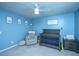 Lovely Bedroom featuring a gray crib, cozy glider, and soft blue walls at 1110 Sapling Dr, Summerville, SC 29485