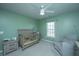 Well-lit Bedroom featuring a gray crib, recliner, and soft green walls at 1110 Sapling Dr, Summerville, SC 29485