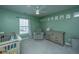 Green Bedroom with a crib, dresser, recliner, and lots of natural light at 1110 Sapling Dr, Summerville, SC 29485