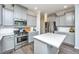 Well-lit kitchen features gray cabinetry, stainless steel appliances, and a center island with a quartz countertop at 1110 Sapling Dr, Summerville, SC 29485