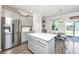 Bright kitchen boasts gray cabinets, stainless appliances, and an island; adjoins eating area and backyard access at 1110 Sapling Dr, Summerville, SC 29485