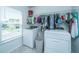 Functional laundry room featuring modern washer and dryer units, and organized hanging space at 1110 Sapling Dr, Summerville, SC 29485
