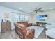 Cozy living room featuring a leather sectional sofa, ceiling fan and a large TV for relaxing evenings at 1110 Sapling Dr, Summerville, SC 29485