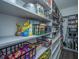 Organized pantry with shelving stocked with various food items and black metal baskets at 1110 Sapling Dr, Summerville, SC 29485