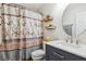 Bathroom featuring a shower with a patterned curtain, floating shelves and vanity with marble countertop at 112 Red Cypress Dr, Goose Creek, SC 29445