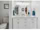 This bathroom features a double sink vanity with round mirrors, a toilet, and blue towels at 112 Red Cypress Dr, Goose Creek, SC 29445