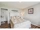 This bedroom features a wooden headboard, cozy bedding, and dark wood flooring at 112 Red Cypress Dr, Goose Creek, SC 29445
