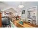Bright dining area with hardwood floors, a wooden table, and access to the living room and kitchen at 112 Red Cypress Dr, Goose Creek, SC 29445