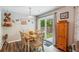 Cozy dining area featuring hardwood floors, a wooden table, and a sliding door leading to the backyard at 112 Red Cypress Dr, Goose Creek, SC 29445