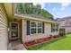 Welcoming front entrance with storm door and manicured flowerbeds at 112 Red Cypress Dr, Goose Creek, SC 29445
