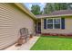 Inviting front porch with a cozy bench and well-manicured landscaping at 112 Red Cypress Dr, Goose Creek, SC 29445