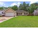 Single-story home with an attached garage and lush green lawn at 112 Red Cypress Dr, Goose Creek, SC 29445