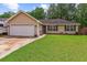 Charming single-story home with a well-maintained lawn and attached garage at 112 Red Cypress Dr, Goose Creek, SC 29445