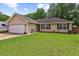 Charming single-story home with a well-maintained lawn and attached garage on a sunny day at 112 Red Cypress Dr, Goose Creek, SC 29445