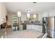 Bright kitchen with a granite island, stainless steel appliances, white cabinets, and stylish pendant lighting at 112 Red Cypress Dr, Goose Creek, SC 29445