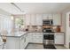 Bright kitchen with stainless steel appliances, white cabinets, granite counters, and a kitchen island at 112 Red Cypress Dr, Goose Creek, SC 29445