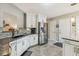 Well-lit kitchen features stainless steel appliances, white cabinetry, gray backsplash, and gray floor tiling at 112 Red Cypress Dr, Goose Creek, SC 29445