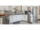 Modern kitchen with stainless steel appliances, granite countertops, white cabinetry, and a gray tiled backsplash at 112 Red Cypress Dr, Goose Creek, SC 29445