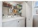 Laundry room featuring a white washer and dryer set, shelving, and storage solutions at 112 Red Cypress Dr, Goose Creek, SC 29445
