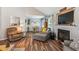 Comfortable living room with hardwood floors, a fireplace, and a cozy seating area, creating a relaxing space at 112 Red Cypress Dr, Goose Creek, SC 29445