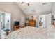 This main bedroom features a vaulted ceiling, wooden furniture, and views of the bathroom and office at 112 Red Cypress Dr, Goose Creek, SC 29445