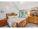 This main bedroom features wood furniture, patterned bedding, and a vaulted ceiling at 112 Red Cypress Dr, Goose Creek, SC 29445
