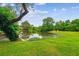 Scenic view of the pond with beautiful landscaping and mature trees, creating a peaceful oasis at 112 Red Cypress Dr, Goose Creek, SC 29445