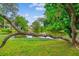 Picturesque pond offering a tranquil view with lush greenery and clear reflections at 112 Red Cypress Dr, Goose Creek, SC 29445