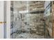 This shower features a stone pebble floor, tile surround, and glass enclosure at 112 Red Cypress Dr, Goose Creek, SC 29445